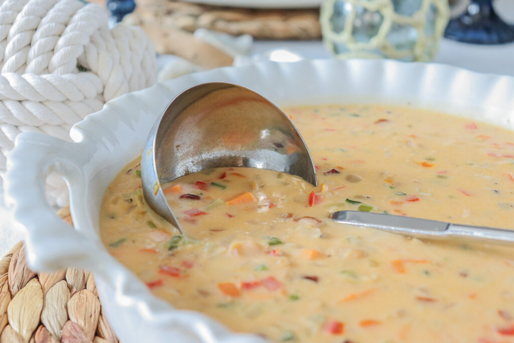 Large bowl of chowder with ladle in it halfway