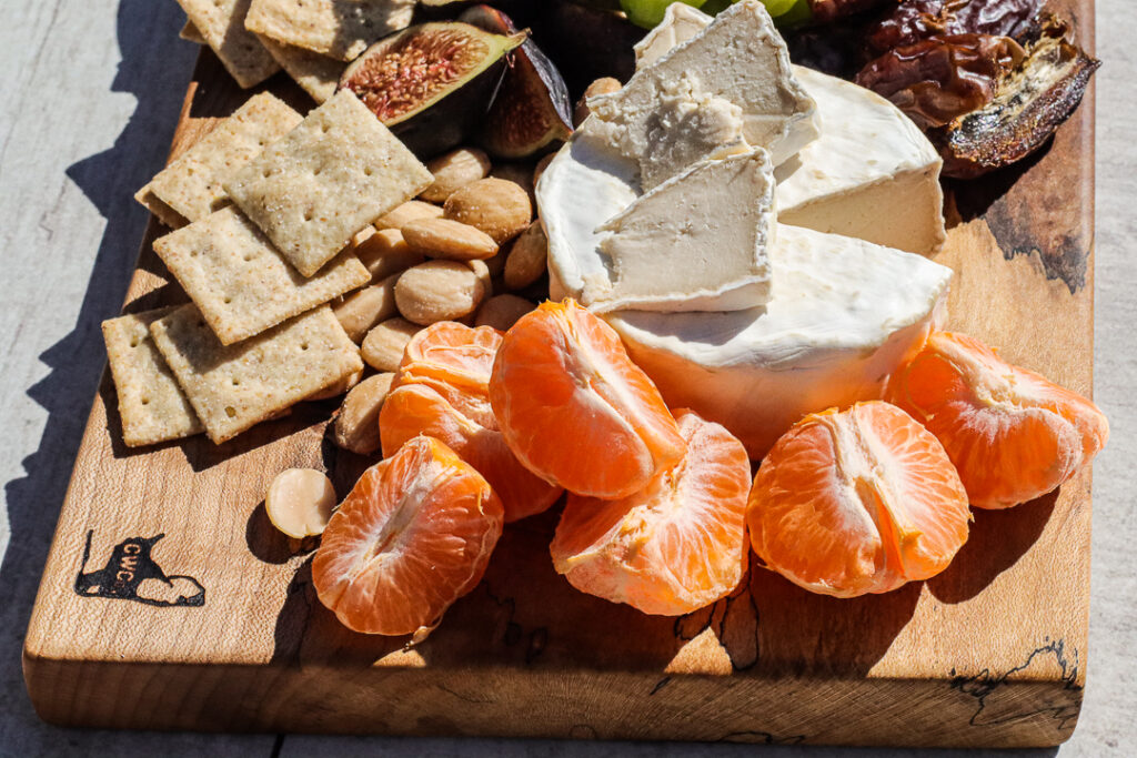 closeup of mandarin oranges on a cheese board